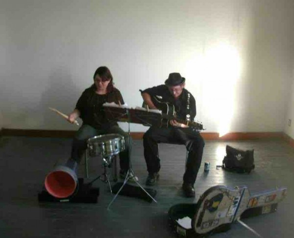 The Local Martyrs, Father Phil and Vanessa Scholle, playing guitar and drums